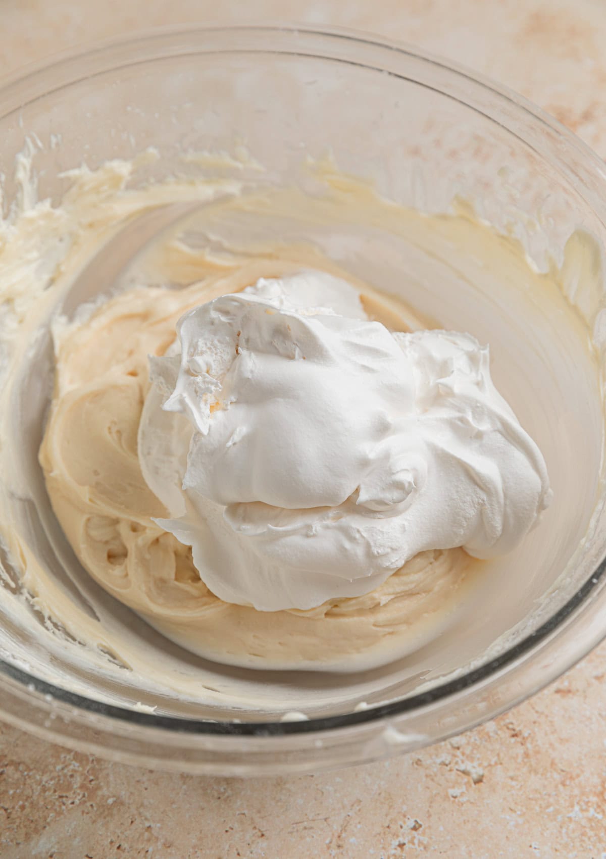 Cool whip added to cream cheese mixture in bowl.