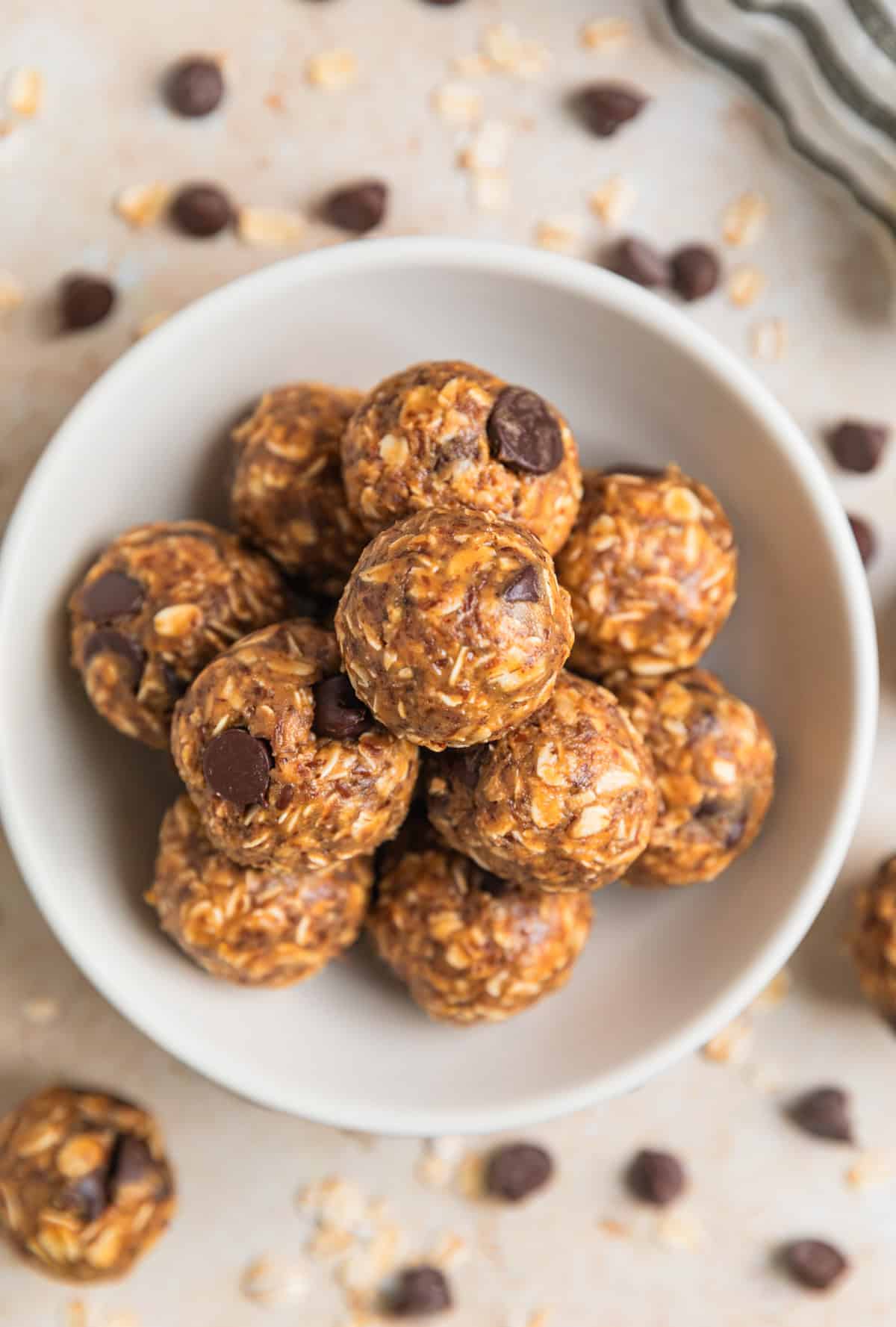 Dish with peanut butter oatmeal balls with dark chocolate chips.