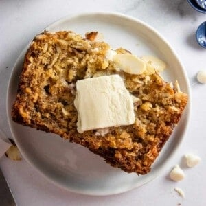 Banana bread on plate with butter.