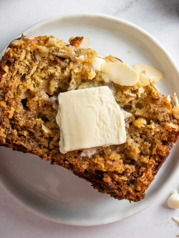 Banana bread on plate with butter.