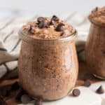 Chocolate overnight oats in a jar with chocolate chips.