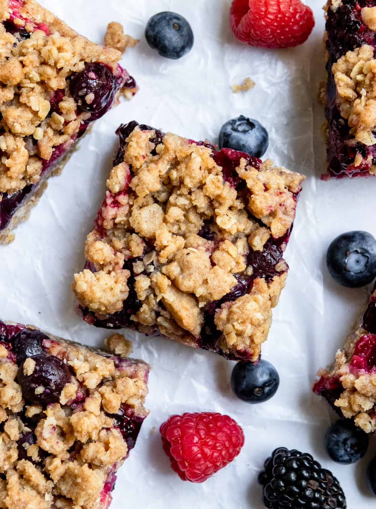 Mixed berry oat bars with crumble topping and fresh berries.
