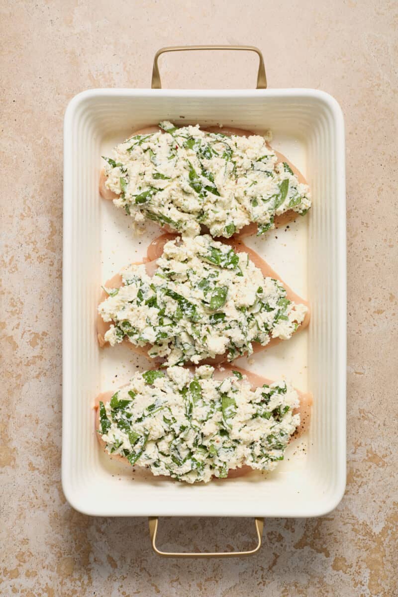 Chicken breasts with spinach ricotta mixture smothered over top.