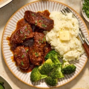 Country style ribs served on plate with bbq sauce.