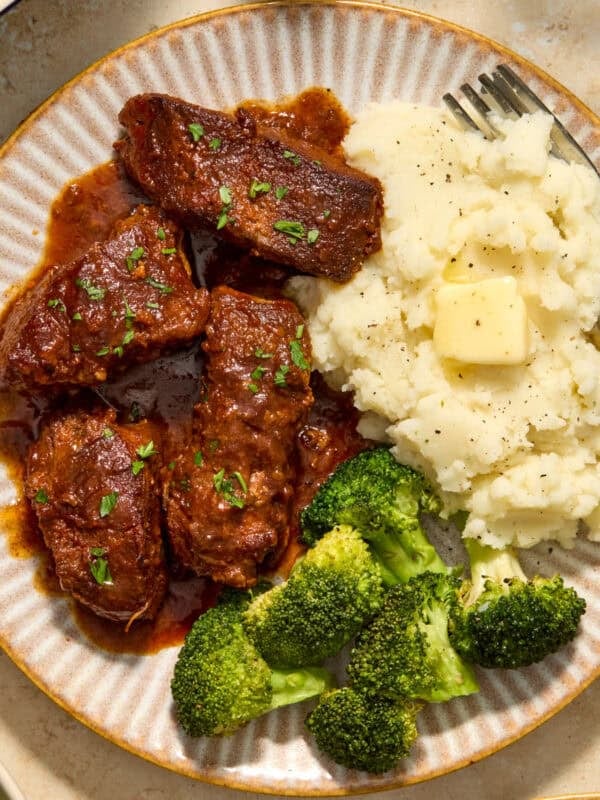 Country style ribs served on plate with bbq sauce.