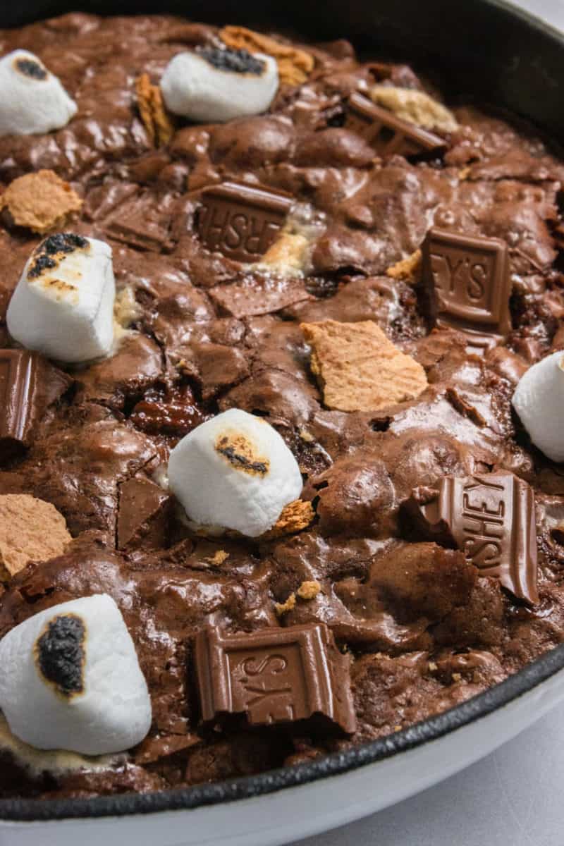 Skillet brownie with chocolate bars, graham crackers and marshmallows.