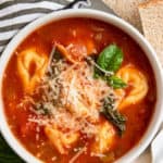 Tomato tortellini soup with basil.