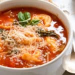 Tomato soup in white bowl with tortellini.
