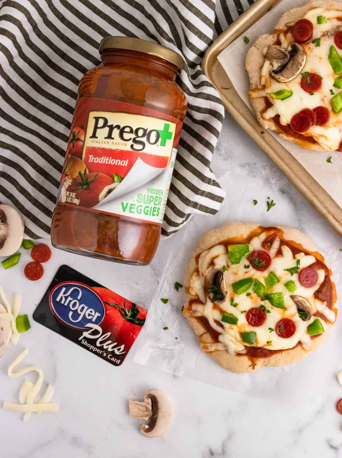 Prego and Kroger card with pizza on counter.