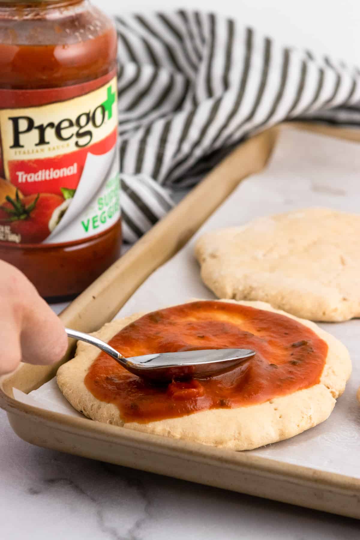Sauce spread onto pizza dough.