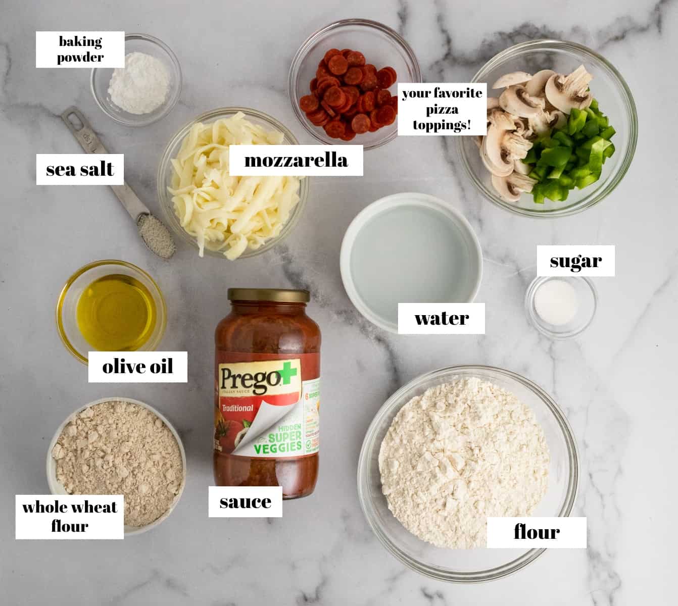 Pizza ingredients labeled on counter.