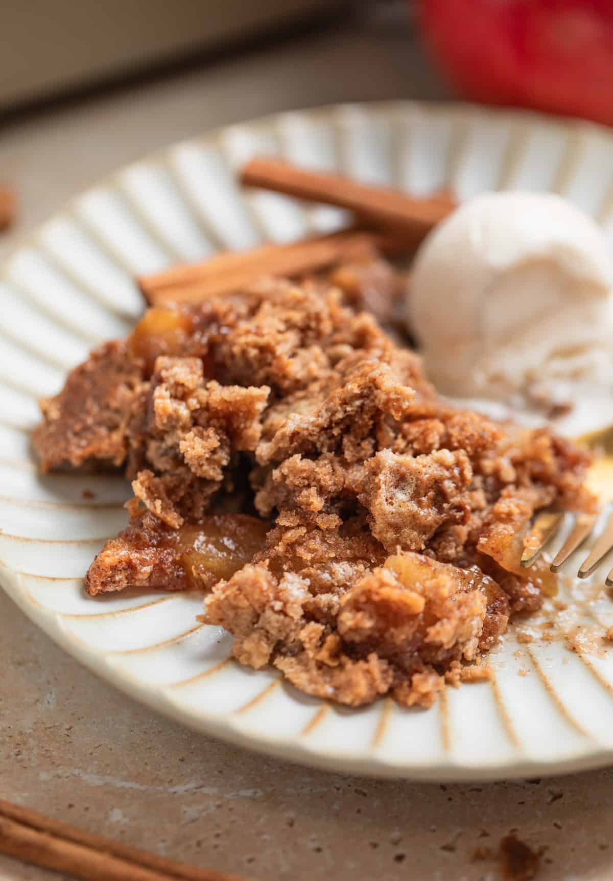 Cinnamon apple dump cake recipe served on dish with vanilla ice cream.