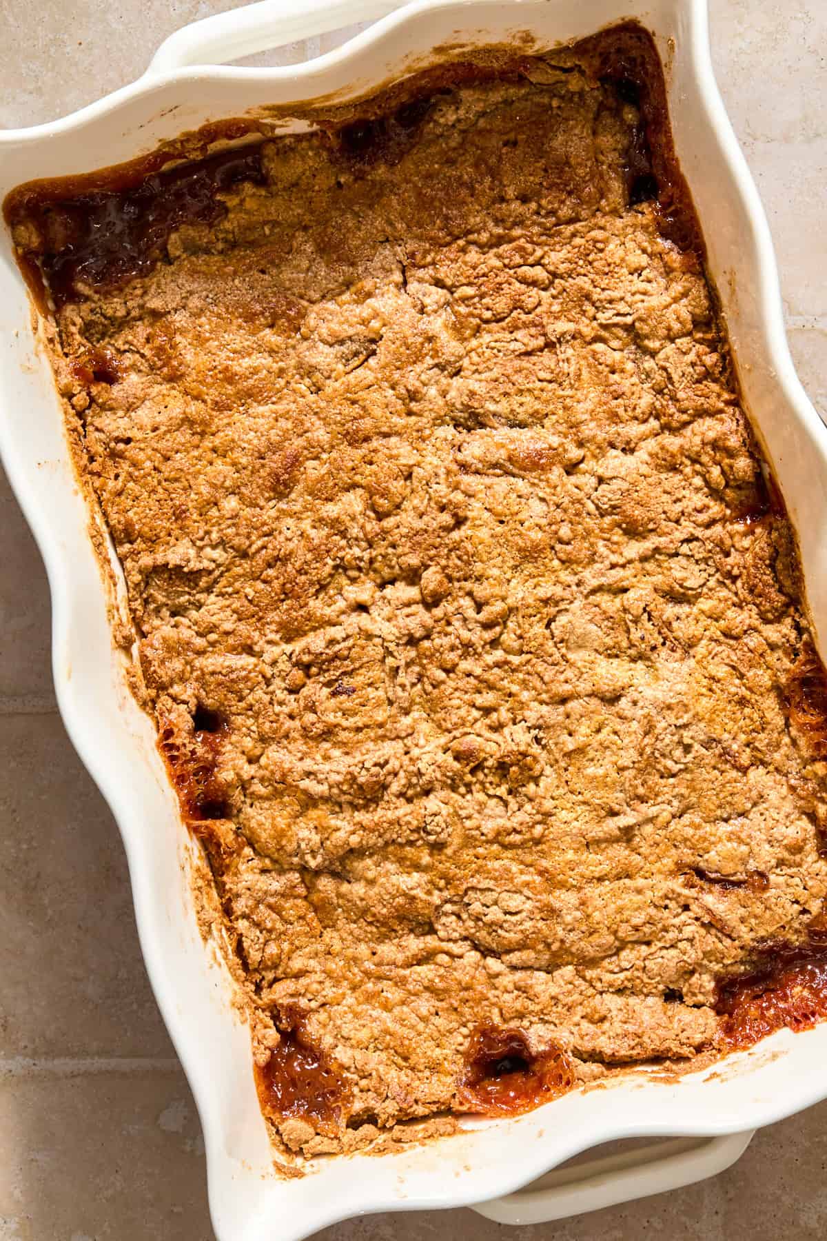 Baked apple dump cake in white pan.