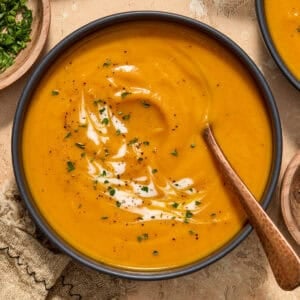 Bowl of carrot sweet potato soup with spoon.