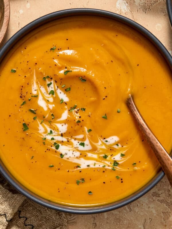 Bowl of carrot sweet potato soup with spoon.