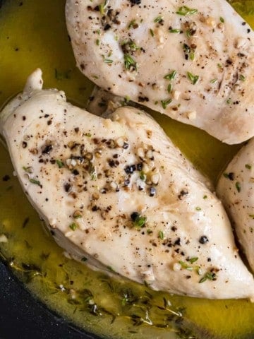 Pan seared chicken in skillet.