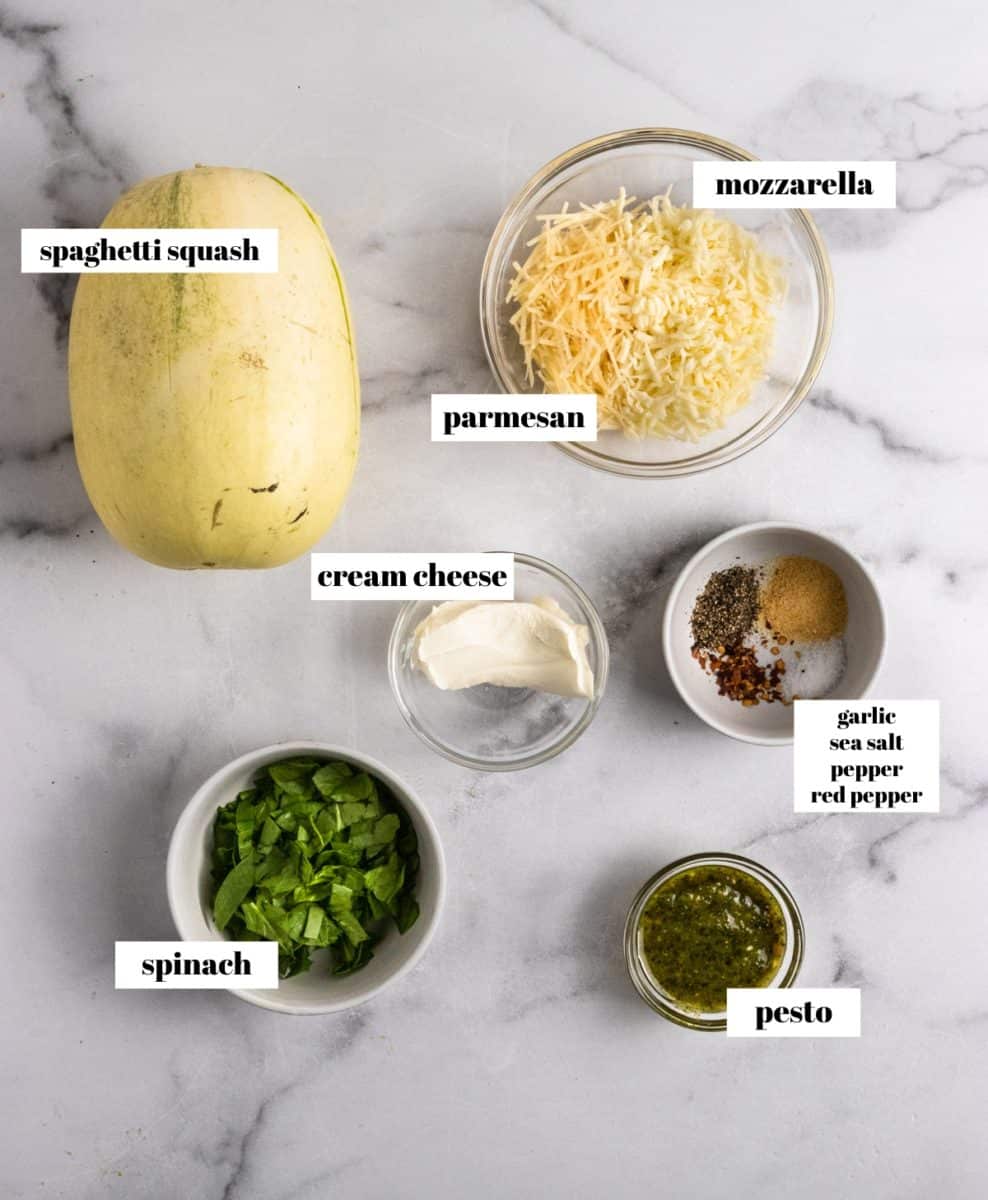 Ingredients to make stuffed spaghetti squash labeled on counter.