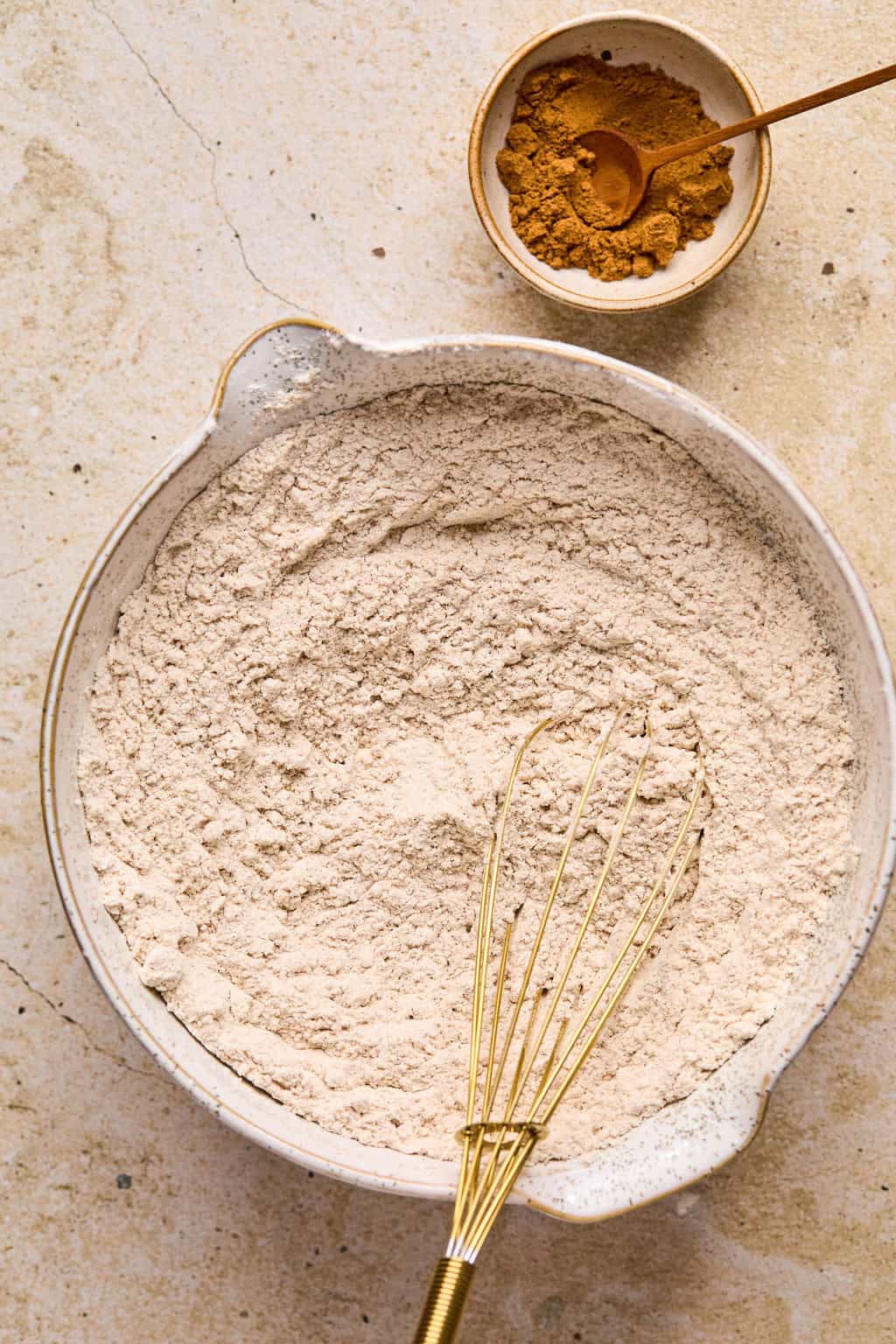 Dry ingredients added to bowl with whisk.