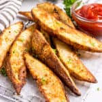 Crispy air fried potato wedges with ketchup.