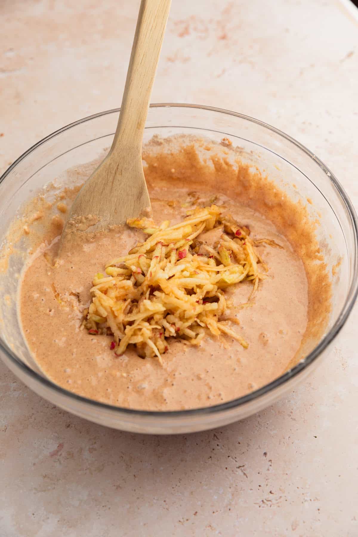 Bowl with grated apples added to batter.