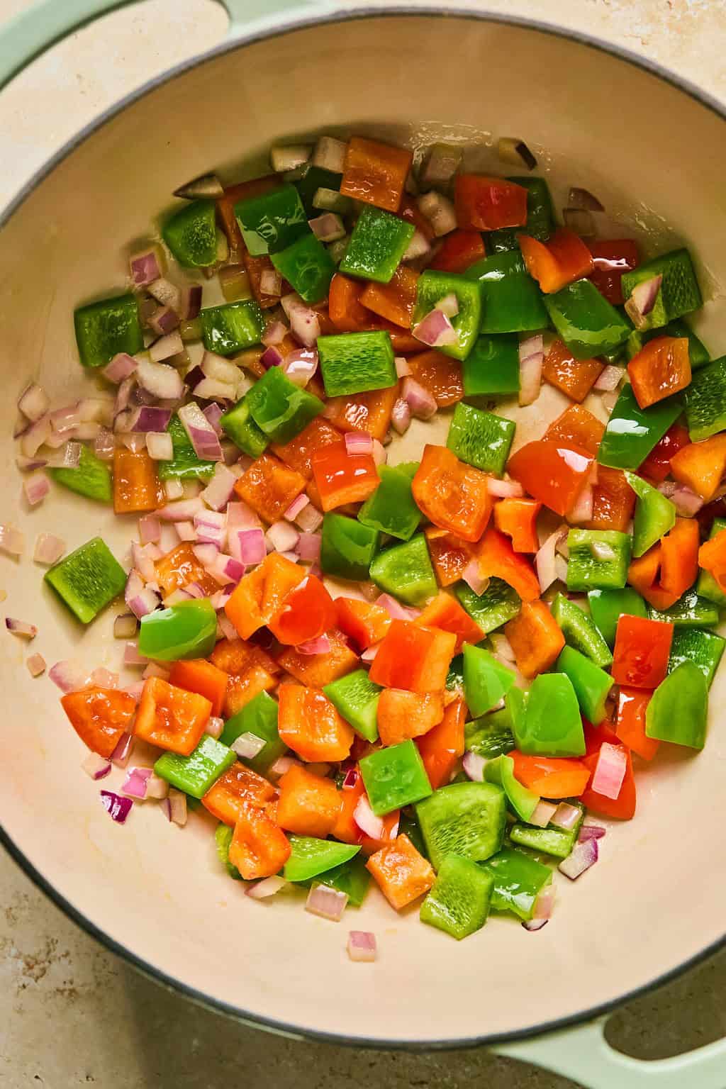 Sautéed onions and pepper in pot.