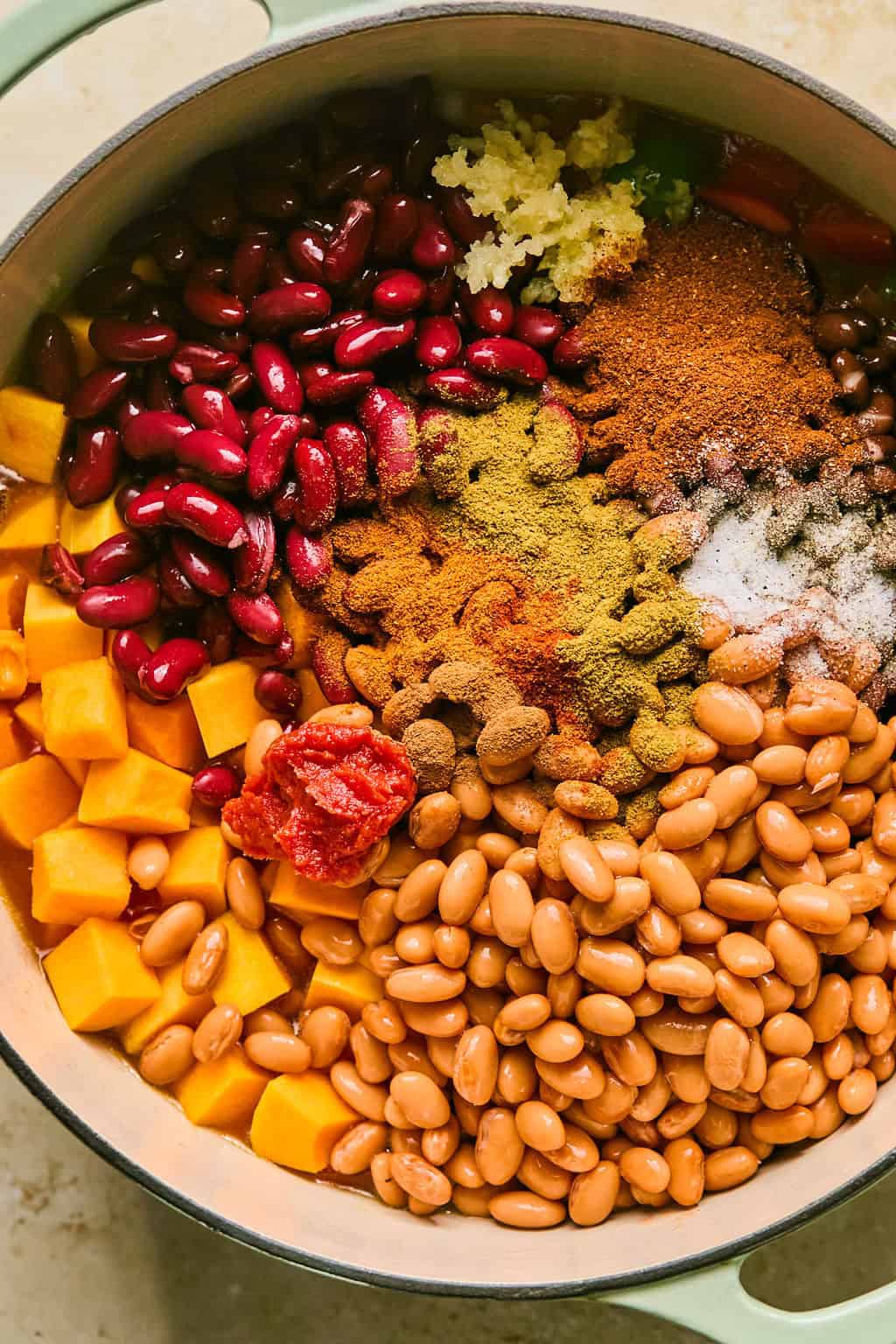 Beans, squash, seasoning, green chiles and other ingredients added to stock pot.