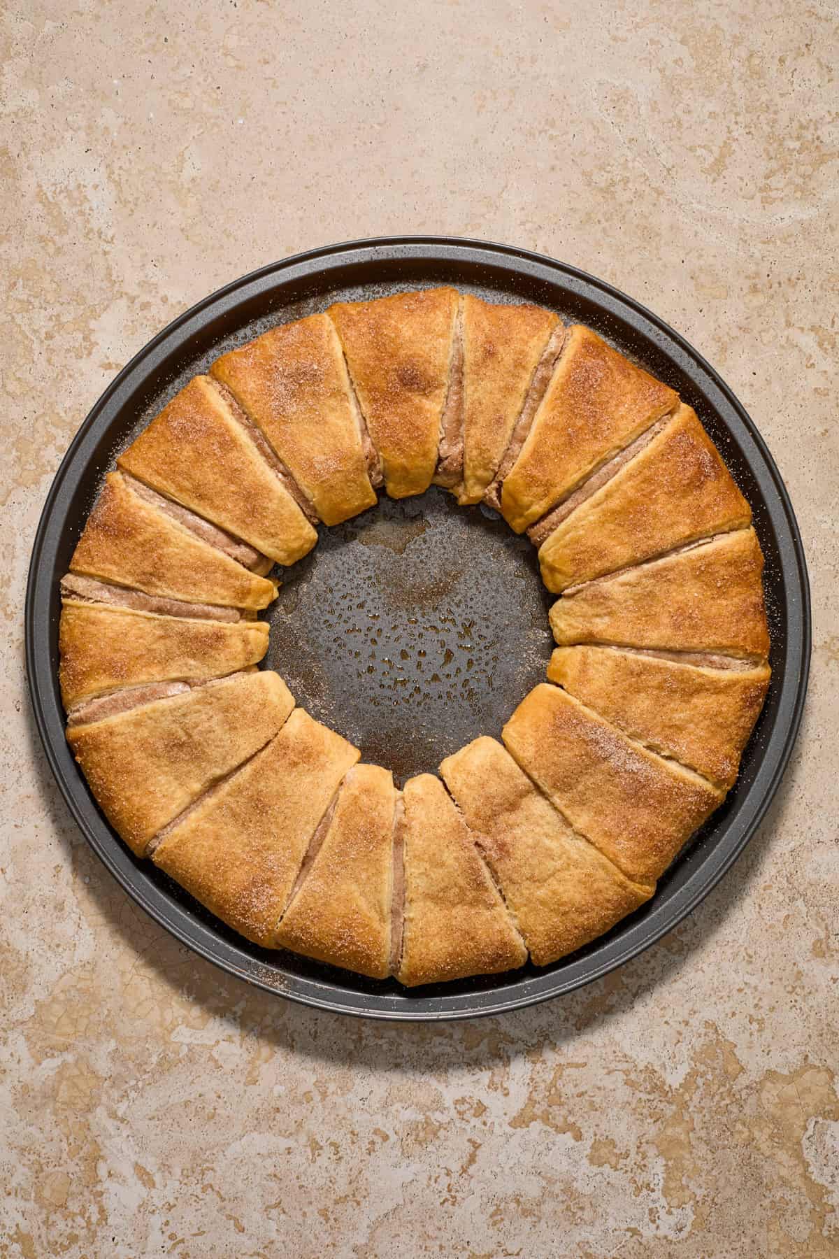Baked crescent roll wreath on pan.