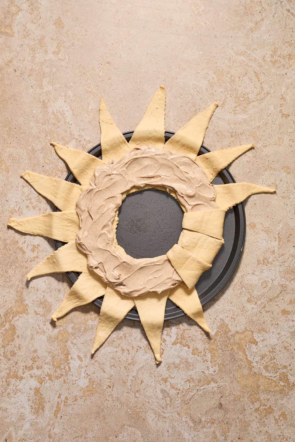Cinnamon cream cheese mixture spread evenly and then several pieces of dough folded over the top.