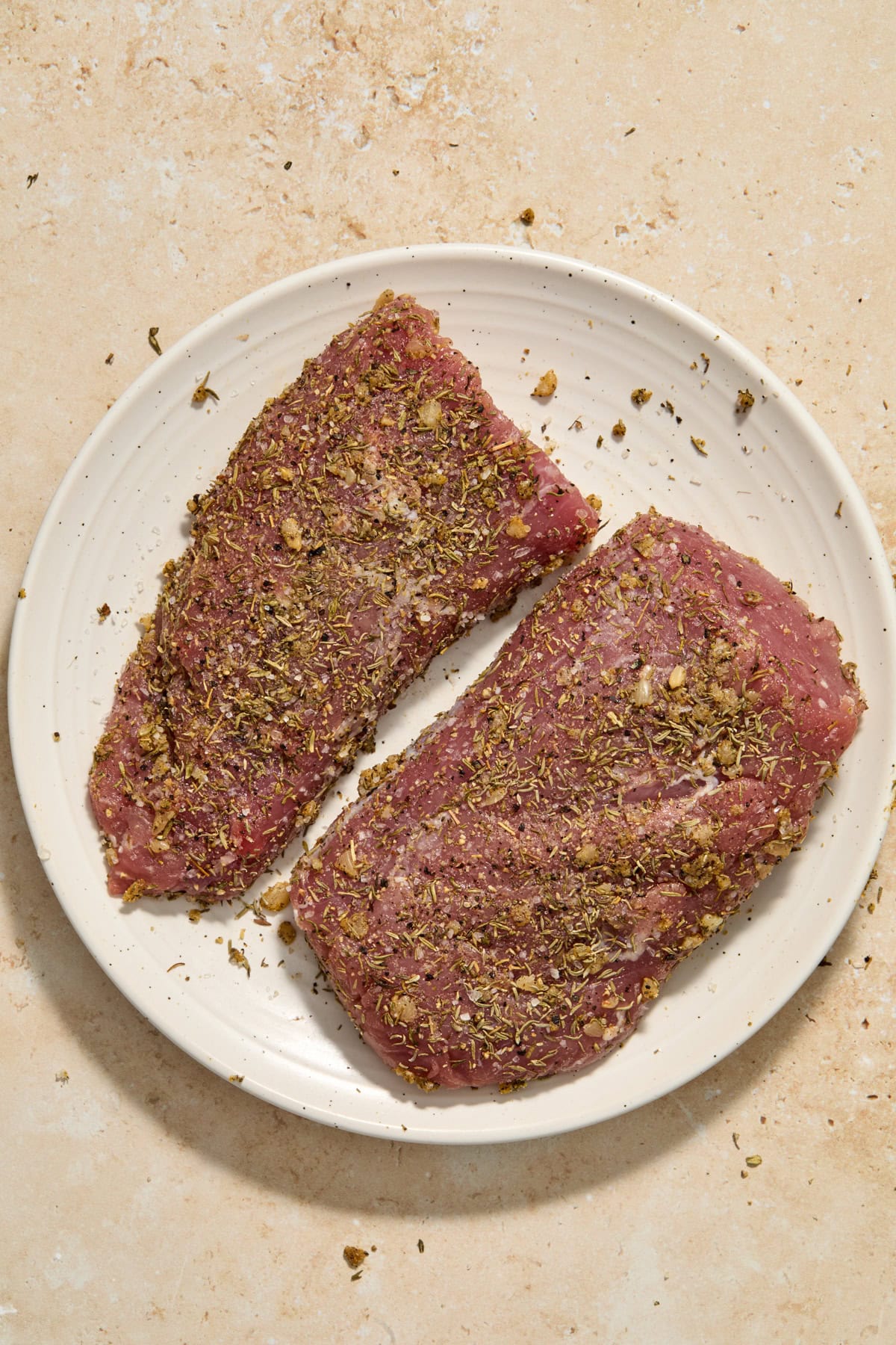 Seasoned pork tenderloin on plate.