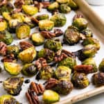 Brussels sprouts with pecans and glaze on pan.