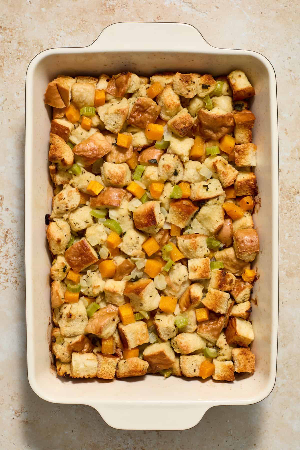 Baked butternut squash stuffing just out of the oven in a pan.