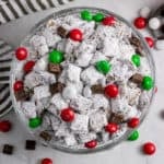 Christmas Puppy Chow in bowl with red and green candies.