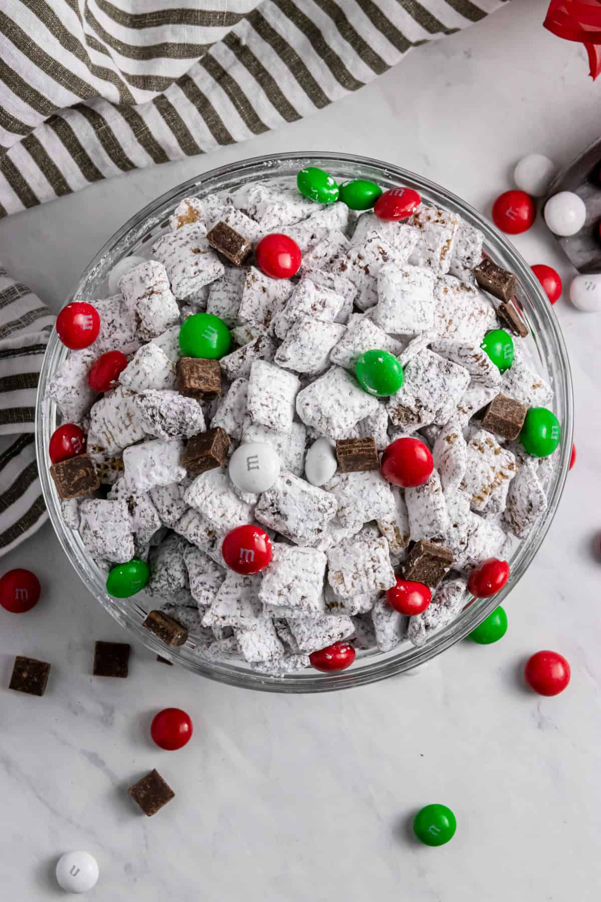 Overhead view of bowl with mint Puppy chow Christmas chex mix.