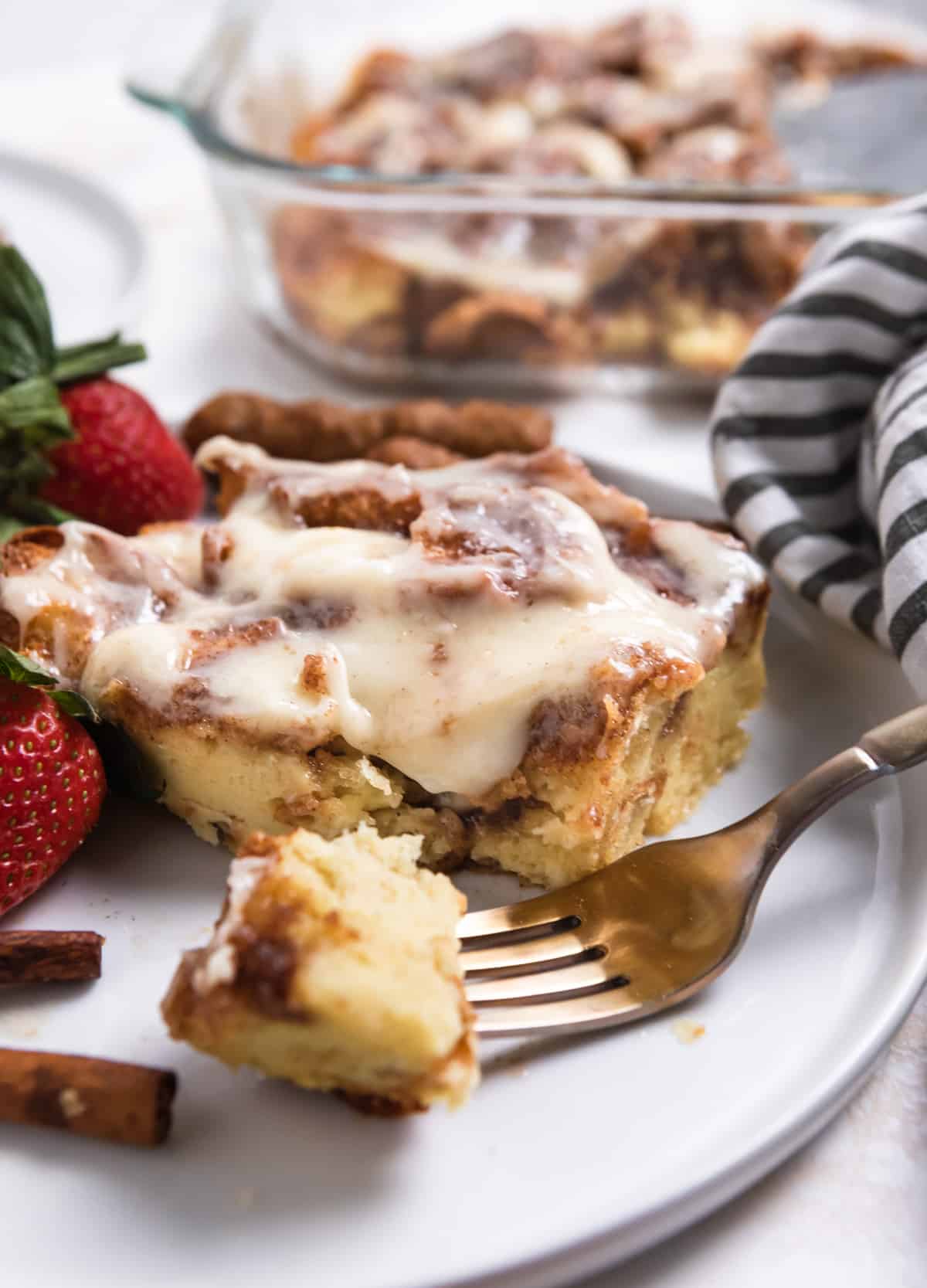 Slice of cinnamon baked french toast on plate with fork.