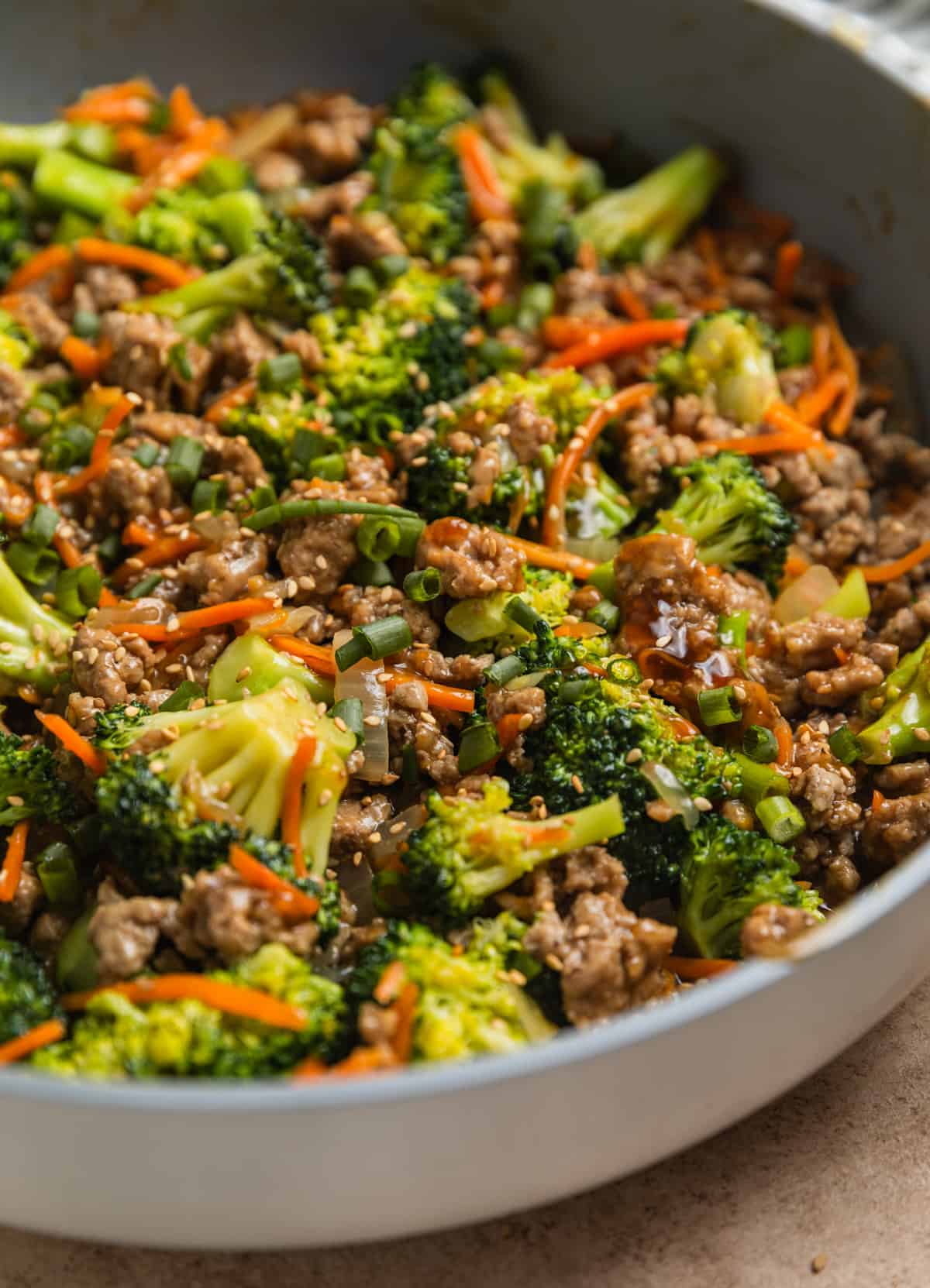 Stir fried ground turkey with carrots and broccoli in pan.