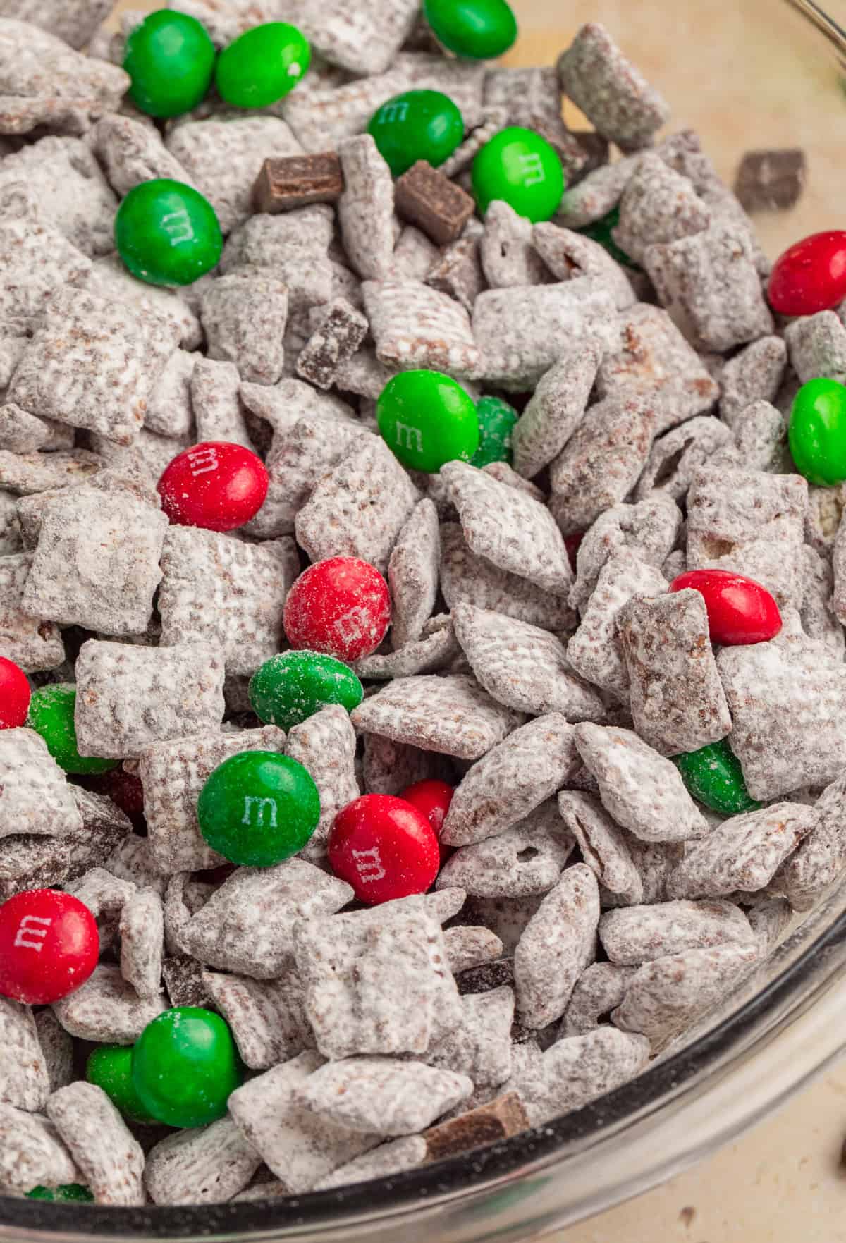 Close up view of mint chocolate Christmas muddy buddies in bowl.