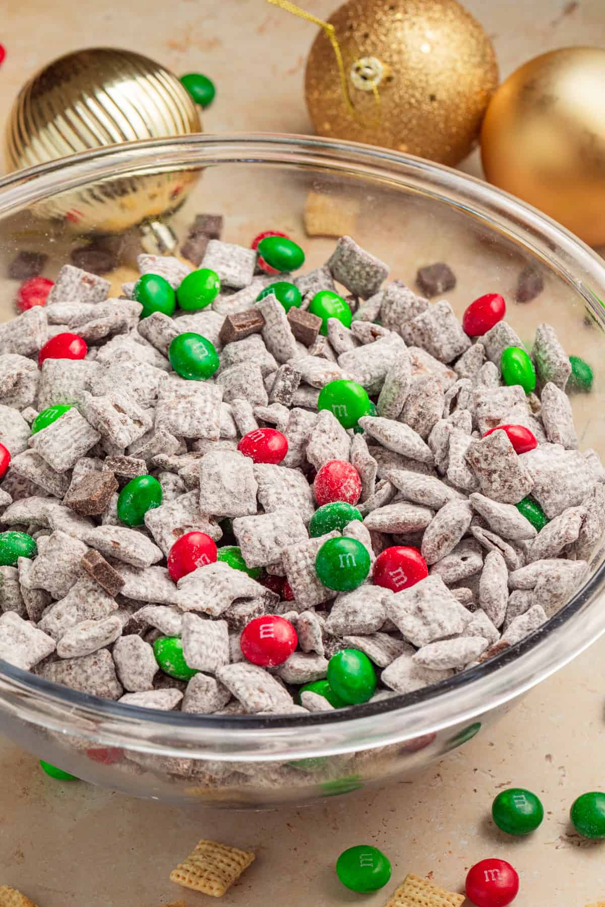 Christmas puppy chow in bowl with red and green candies.