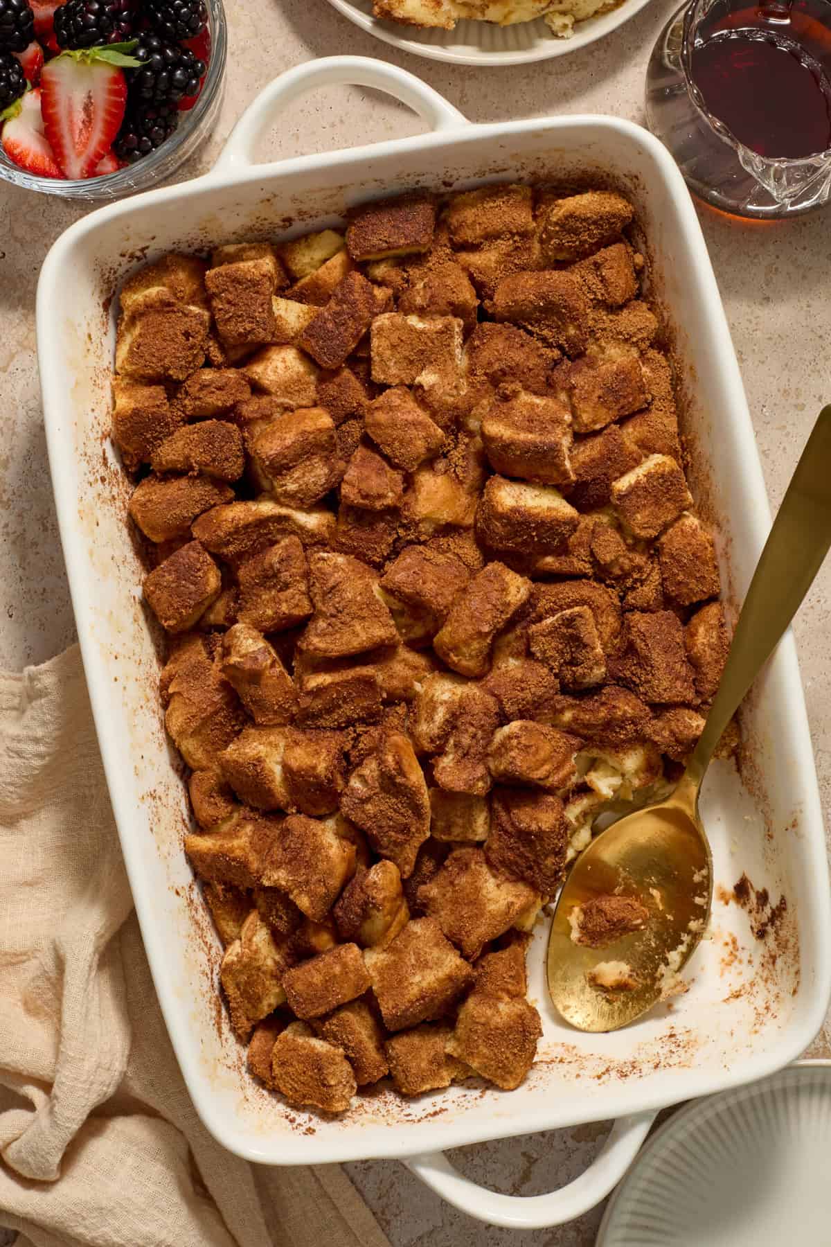 Pan with baked French toast and serving spoon.