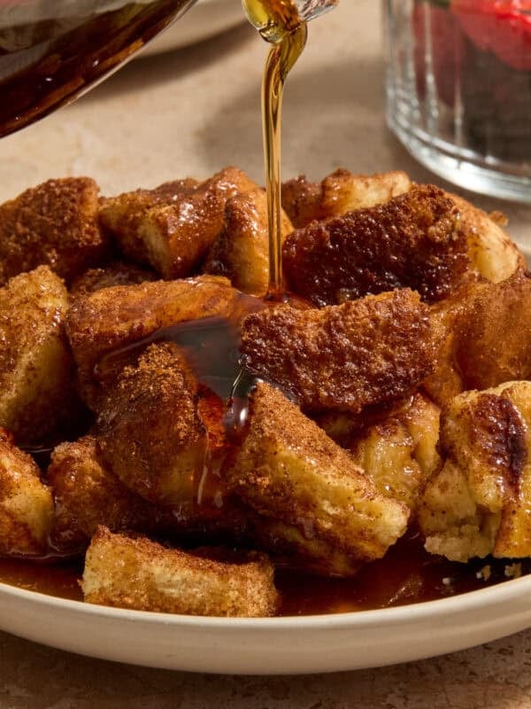 Maple syrup being poured over French toast casserole.