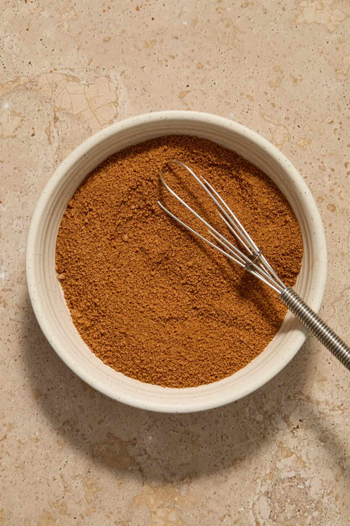Whisked cinnamon and sugar in bowl.