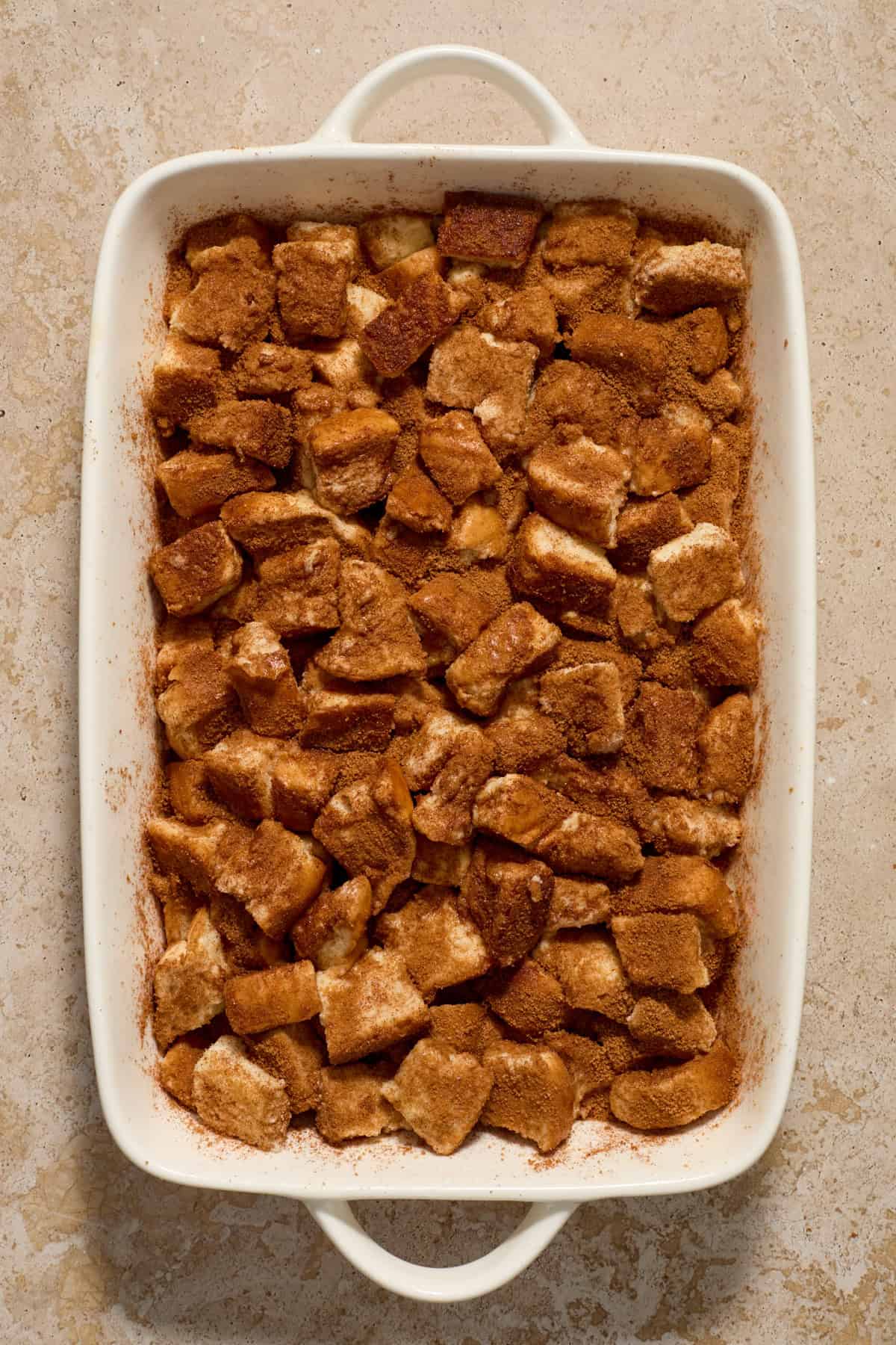 French toast casserole with texas toast tossed with cinnamon and brown sugar before baking.