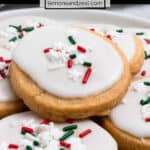 Christmas shortbread cookies with white icing and holiday sprinkles.