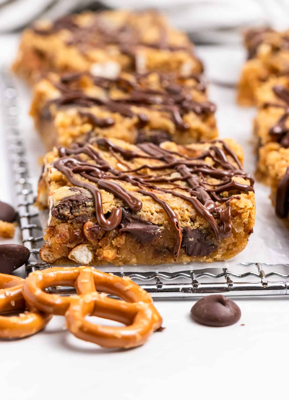 Chickpea blondies on wax paper with chocolate drizzle.