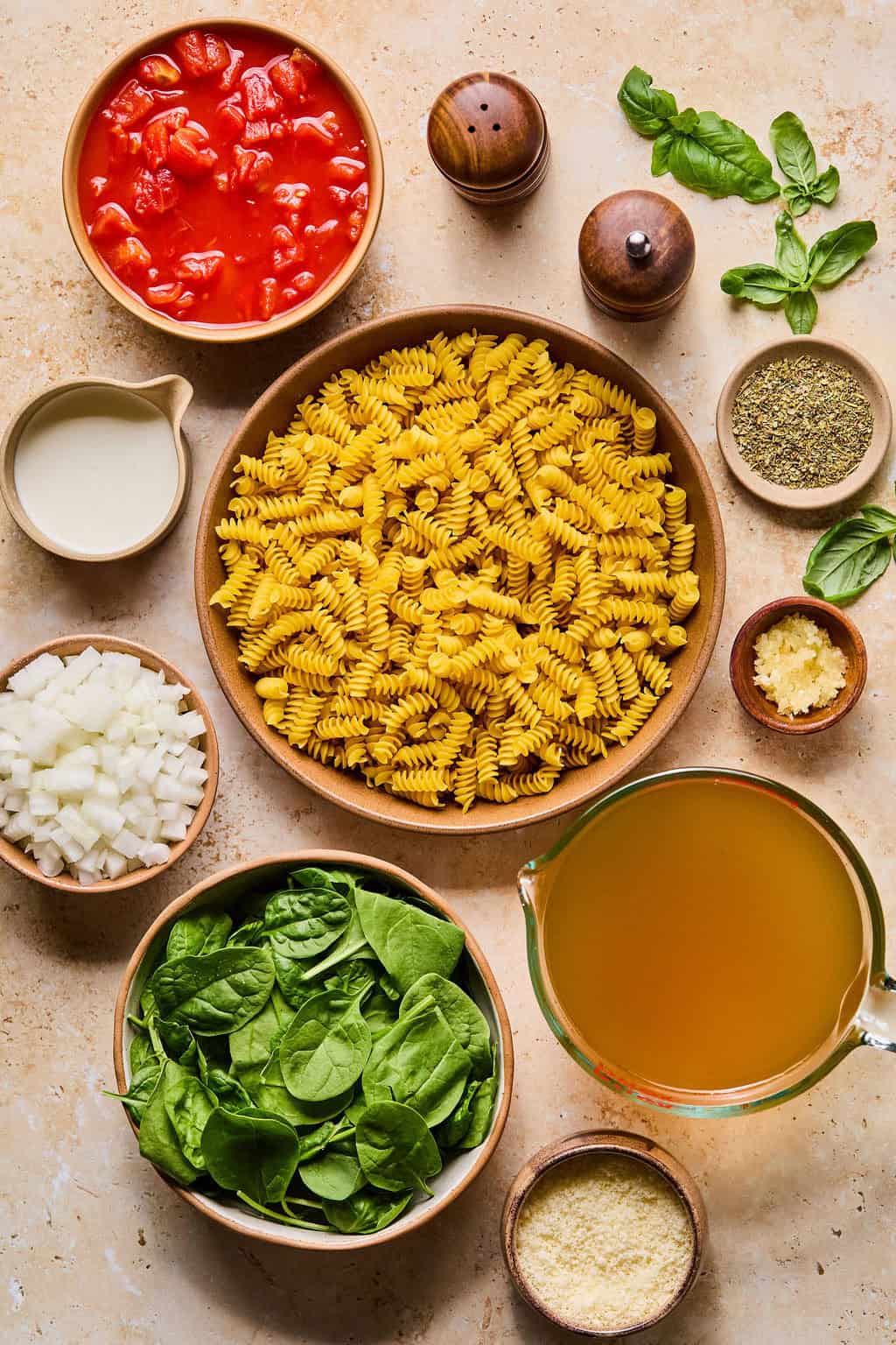 Pasta, cream, cheese, spinach, and other ingredients needed to make recipe.
