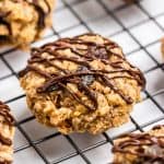 Breakfast cookies on cooling rack with chocolate drizzle.