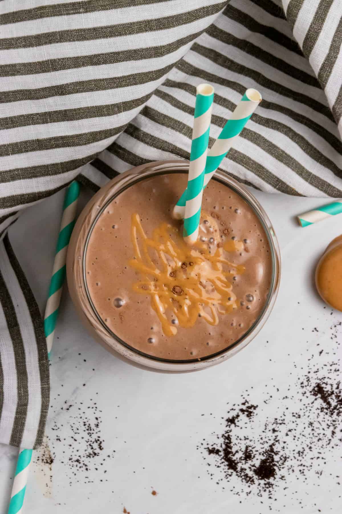 Peanut Butter coffee smoothie with peanut butter drizzle on top.