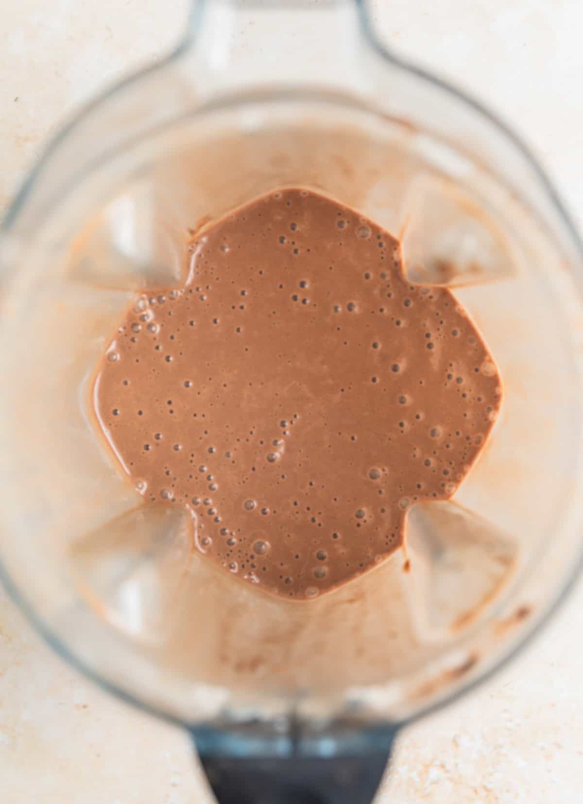 Blender containing peanut butter coffee smoothie.
