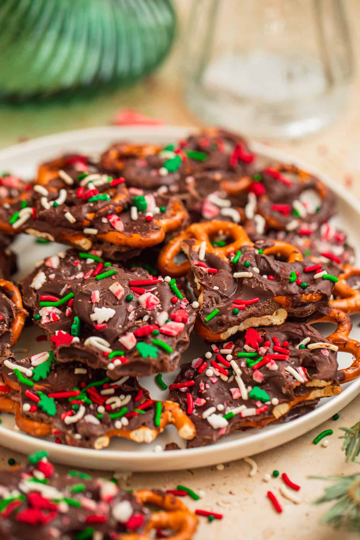 Dish with pieces of dark chocolate bark with pretzel twists in it.