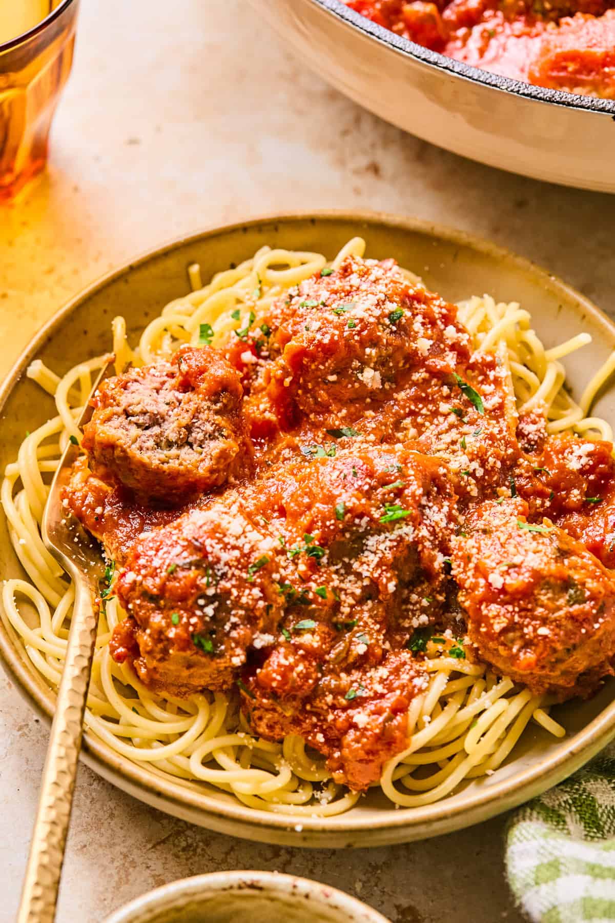 Spaghetti and meatballs in dish with fork.