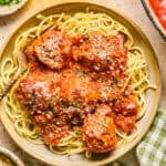 Plate with spaghetti and meatballs topped with fresh parmesan.